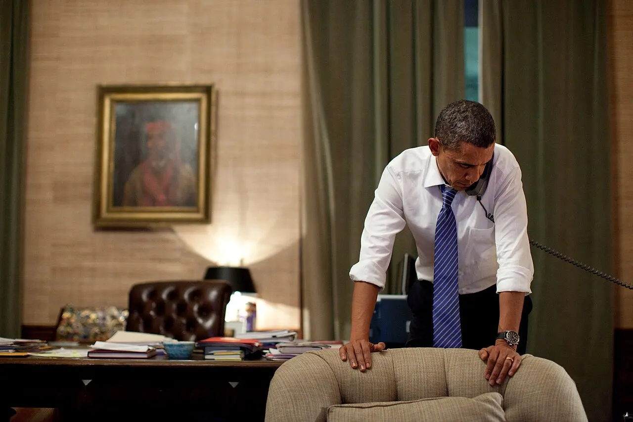 President Barack Obama talks on the phone with President Lee Myung-bak of South Korea in the Treaty Room Office in the White House residence, Nov. 23, 2010. Ear