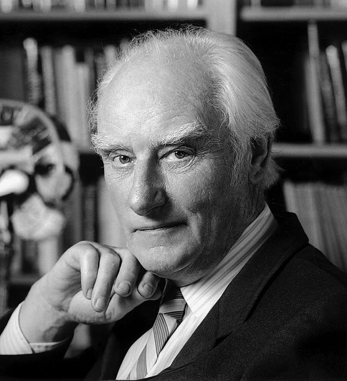 Francis Crick in his office. Behind him is a model of the human brain that he inherited from Jacob Bronowski.